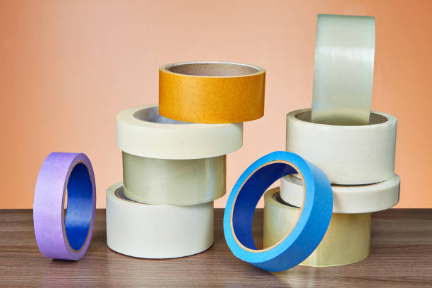 istock Duct tape in assortment lies on table on orange background. 964387364
