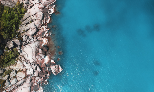 Aerial view of rock cliff surrounded sea water. drone shot