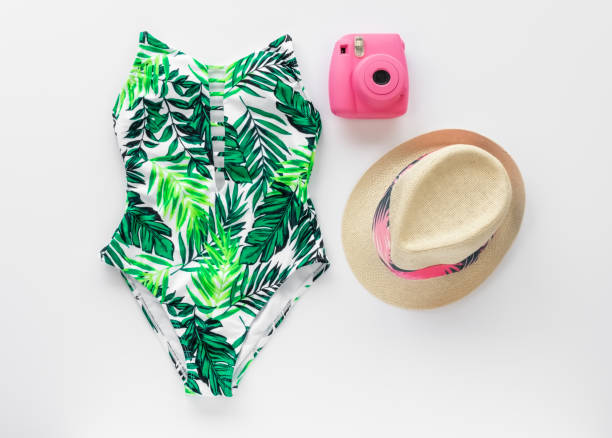 istock Palm Leaf Print Swim Suit, Sun Hat, and Camera Summer Flat Lay Design Template 964391752