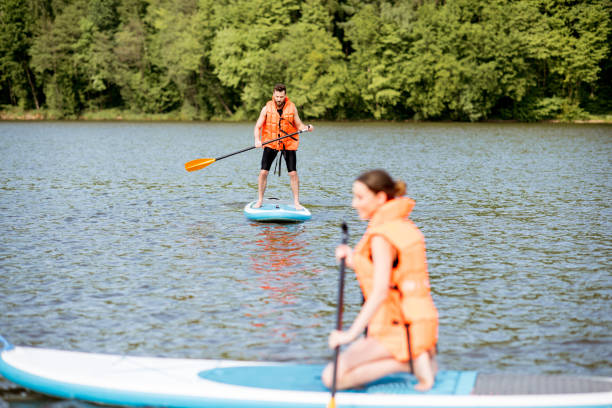 istock Couple rowing on the stand up paddleboard 964391910