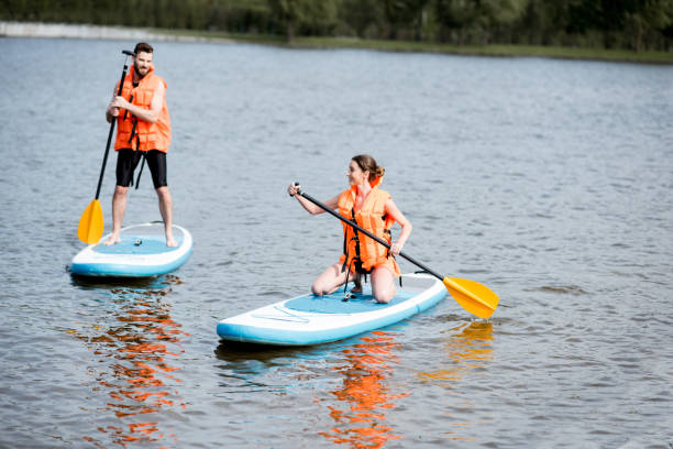 istock Couple rowing on the stand up paddleboard 964391992