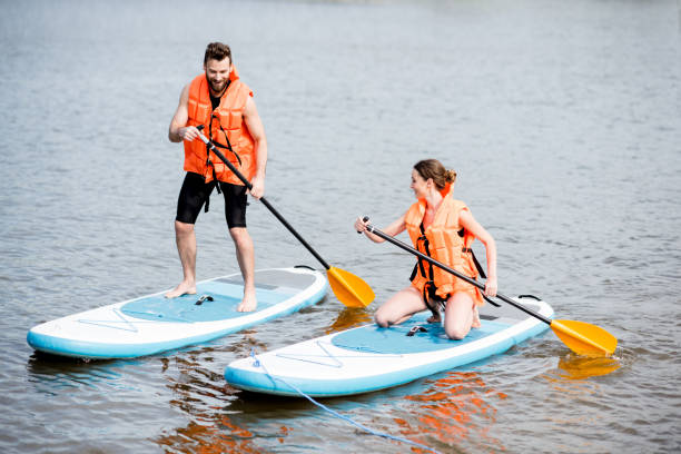 istock Couple rowing on the stand up paddleboard 964392028