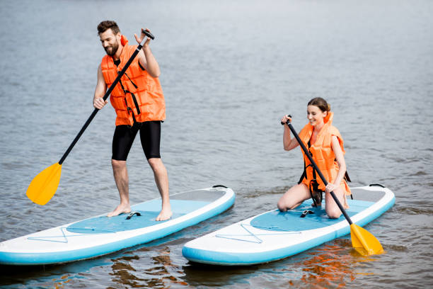istock Couple rowing on the stand up paddleboard 964392054