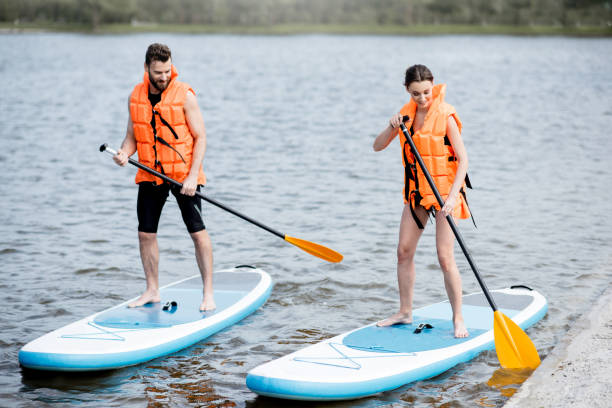 istock Couple rowing on the stand up paddleboard 964392220