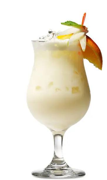 Photo of Glass of pi_a colada cocktail with fruit and straw