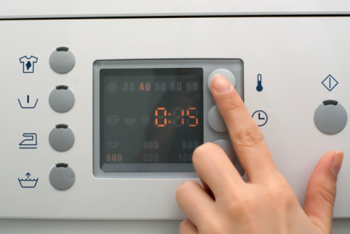 Adjusting wash settings on the control panel of washing machine
