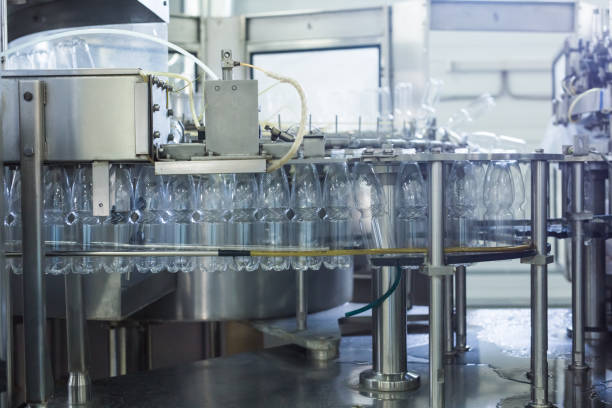 istock Water factory - Water bottling line for processing and bottling pure spring water into small bottles 964409376