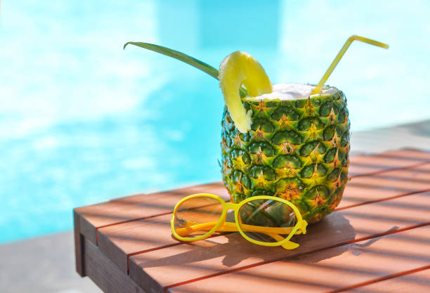istock Exotic pineapple cocktail near pool. Pina colada 964426176