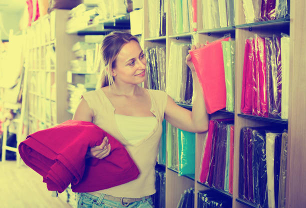 istock Woman shopping tablecloths in home textile store 964453444