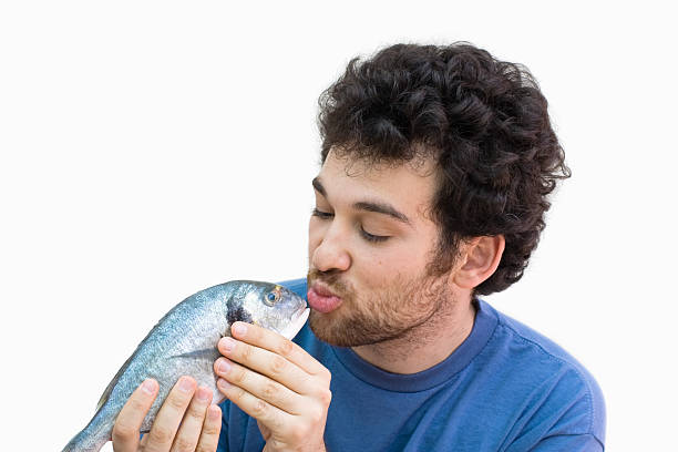 beijando peixe - facial expression unpleasant smell shirt caucasian - fotografias e filmes do acervo