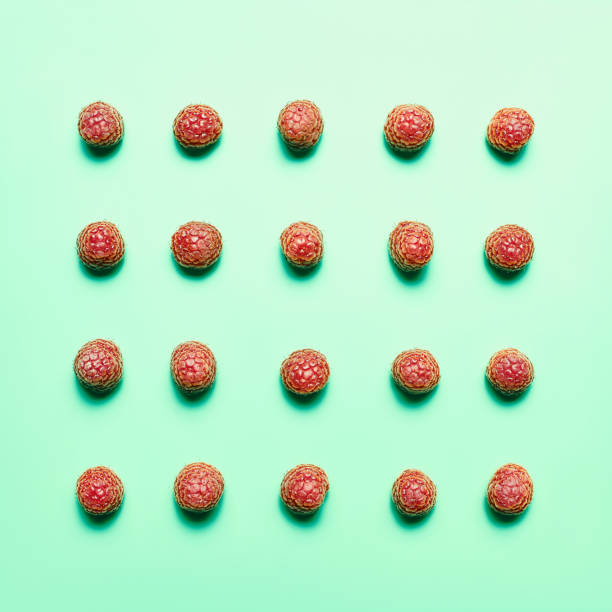 istock Flatlay with ripe organic raspberries arranged on squared mint background, sweet vegan dessert 964480196