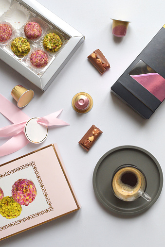 Morning espresso with chocolate and candies flat lay