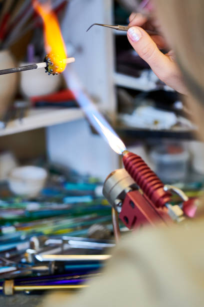istock Female Artist Shaping Glass Beads 964483384