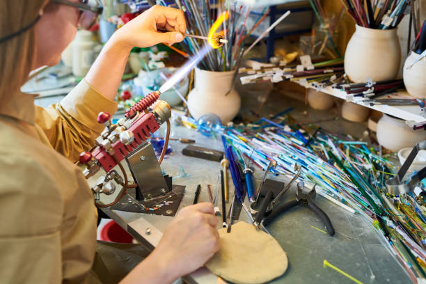 istock Female Artist Shaping Glass in Flame 964483438