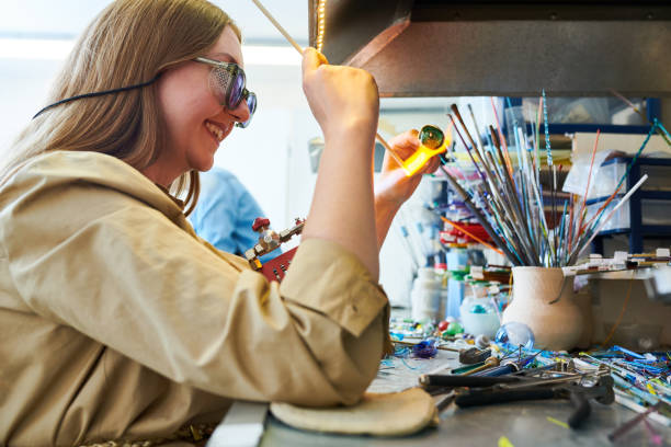 istock Smiling Artist Shaping Glass in Flame 964483454