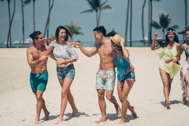 istock Group of young beautiful people on the beach 964483498