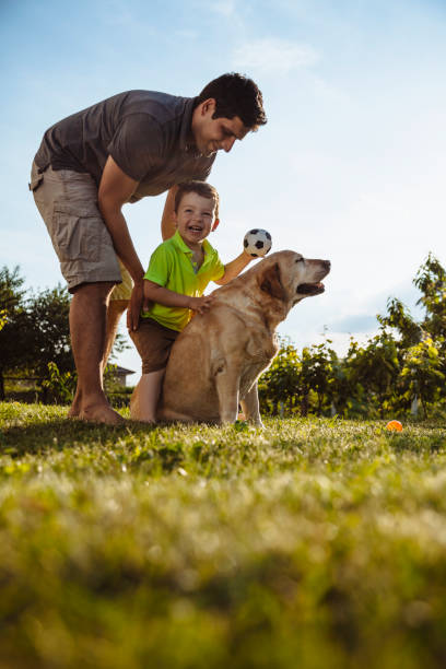 istock Happy boy and father with dog 964487640