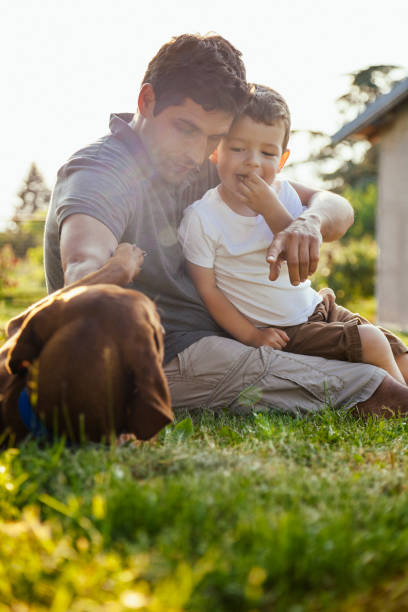 istock Happy boy and father with dog 964490042