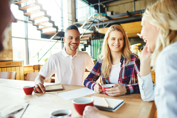 istock Cheerful young business team having fun while brainstorming and discussing ideas 964497862