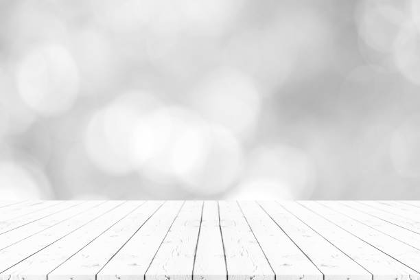istock Perspective empty white wooden table on top over blur background, can be used mock up for montage products display or design layout. 964509850