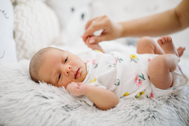 istock Mother's hand stroking newborn baby 964523050