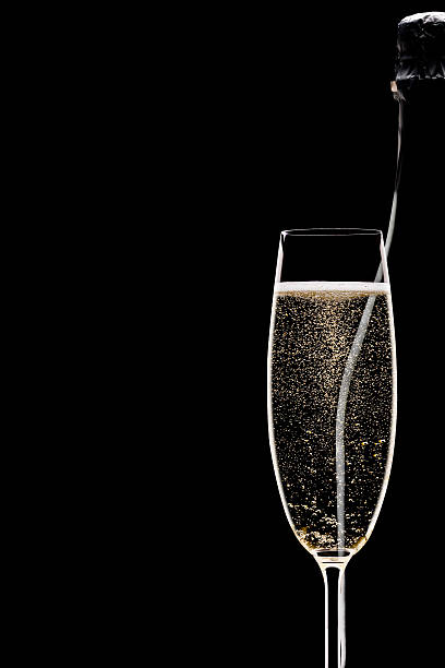 Champagne bottle and glass silhouette on black background stock photo