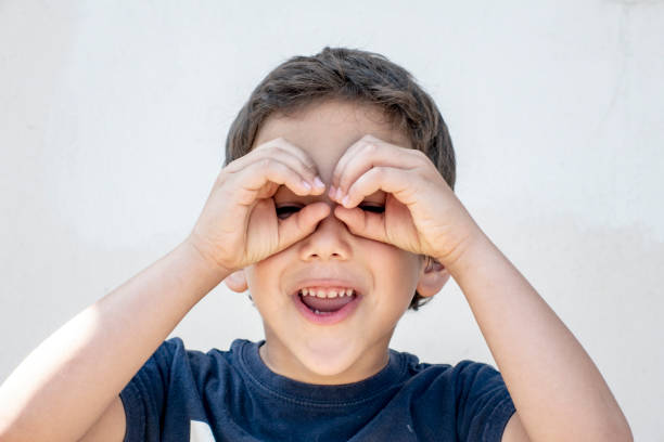 istock Smiling boy did fingers like binoculars 964527442