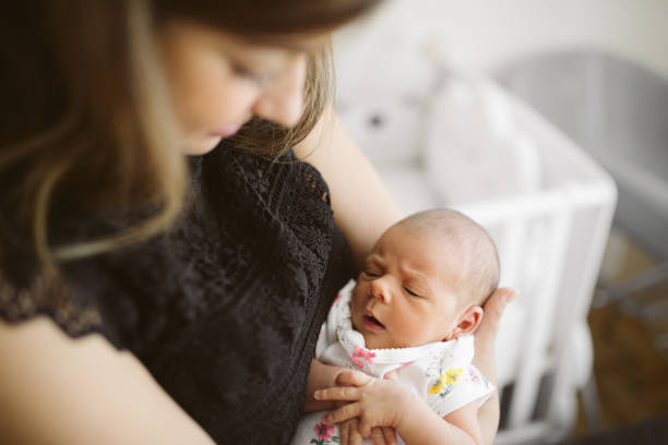 istock Happy young mother holding her baby 964536308