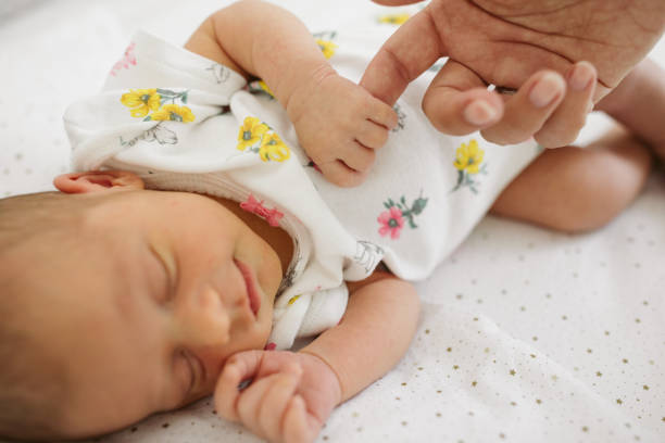 istock Newborn baby holding mother's hand 964536592