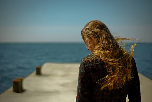istock The girl on seacoast during a storm 96456175