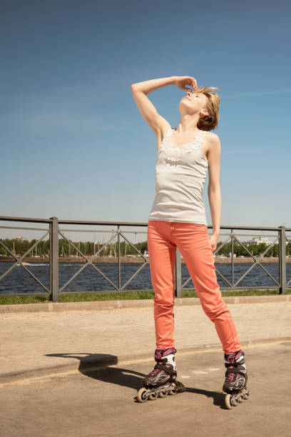 istock Happy young woman on roller skates at sunny day 964563594