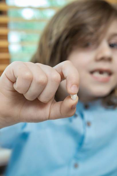 istock Cute little boy with a tooth missing in home. 964563786