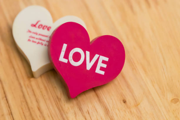 istock Single red  heart isolated  on wooden texture background. 964566702