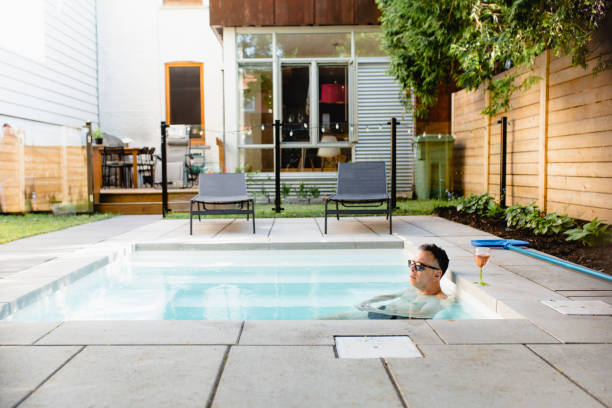istock A man in a swimming pool with pink champagne 964572366