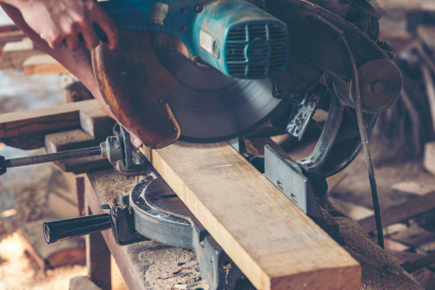 istock Background image of woodworking workshop: carpenters work table with different tools and wood cutting stand, vintage filter image 964576482