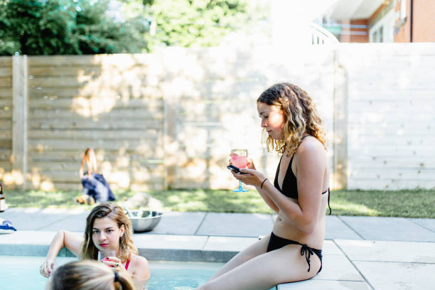 istock Young woman at a pool party 964576506
