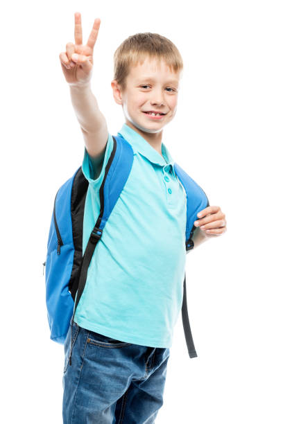istock schoolboy with backpack smiling and showing a hand gesture on a white background isolated 964579230