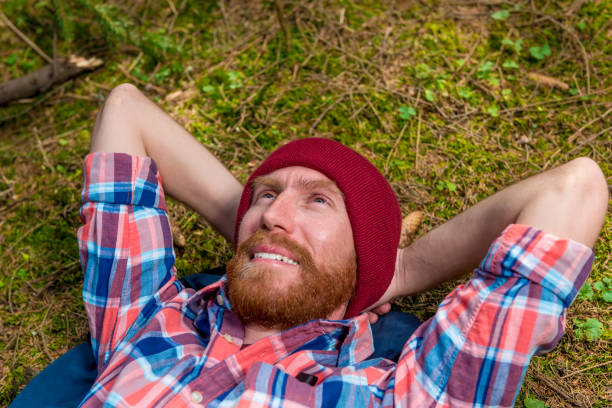 istock happy dreaming forester with a red beard on a forest glade resting 964579588
