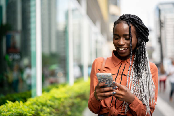 Afro Woman Using Mobile at Street