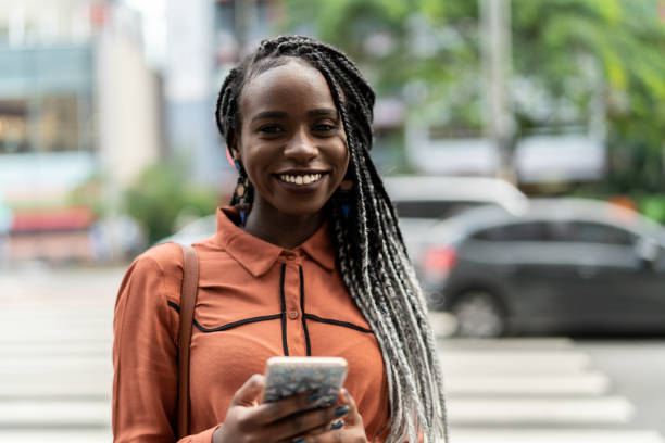 istock Afro Woman Using Mobile at Street 964587356