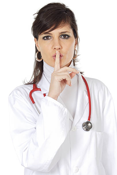 istock An attractive doctor using the quiet sign 96458872