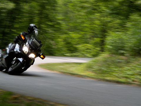 Motorcycle taking corner at high speed.