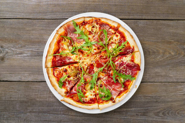 istock Italian pizza with prosciutto and arugula 964592468