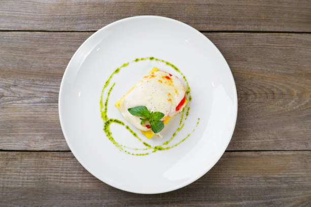 istock Baked corn polenta with mozzarella and pesto sauce. 964594614
