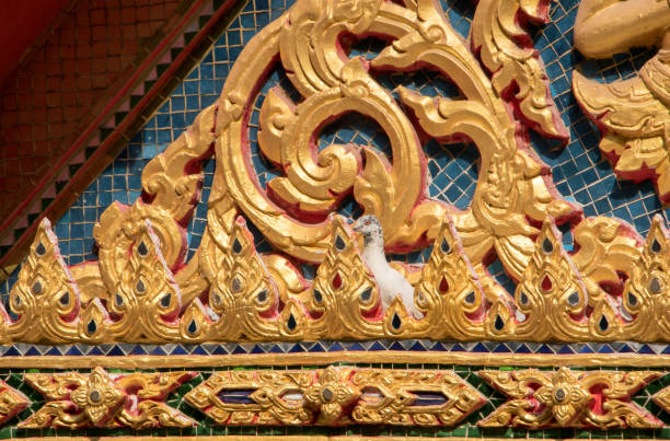 istock Thai golden low relief sculpture on the temple 964602874