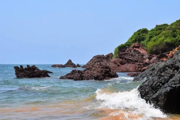 Sea waves crashing against the rocks captured from Monkey beach island, Goa, India