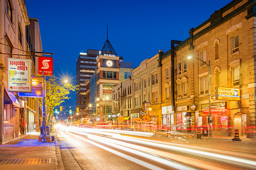 Stock photograph of cars driving on Richmond Street in downtown London Ontario Canada at twilight blue hour.