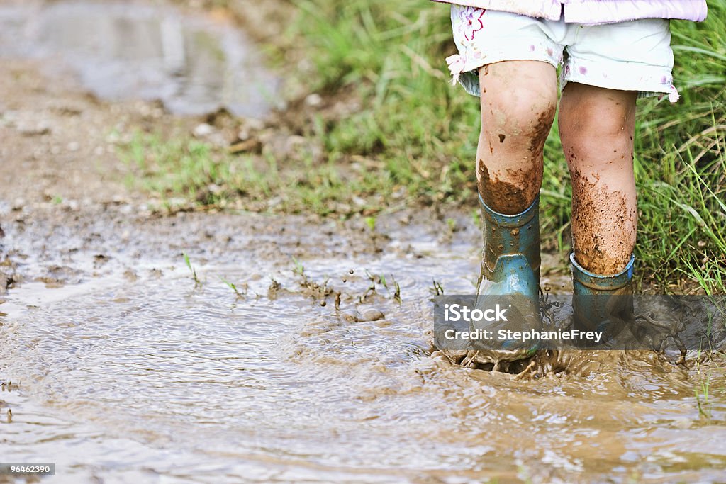 Child playing in mud Child's feet stomping in a mud puddle.  Mud Stock Photo