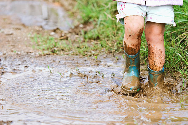 Child playing in mud stock photo