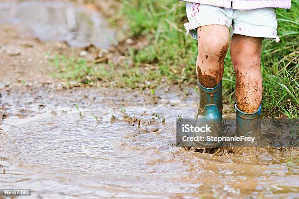 Child Playing In Mud Stock Photo - Download Image Now - Mud, Child, Rubber Boot